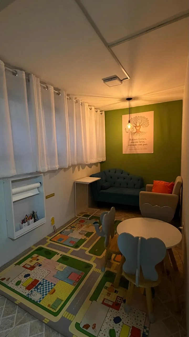 Sala infantil da ABCD com tapete lúdico, mesinha e sofá acolhedor